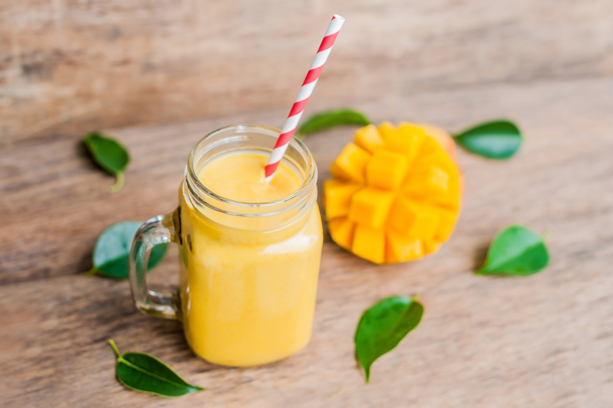 Mango Smoothie  in Glass Mason Jar with Striped Red Straw