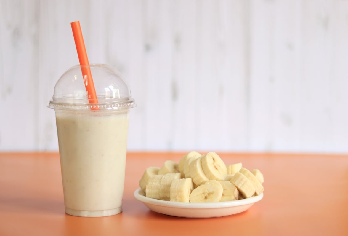 Banana smoothie with a plastic disposable cup